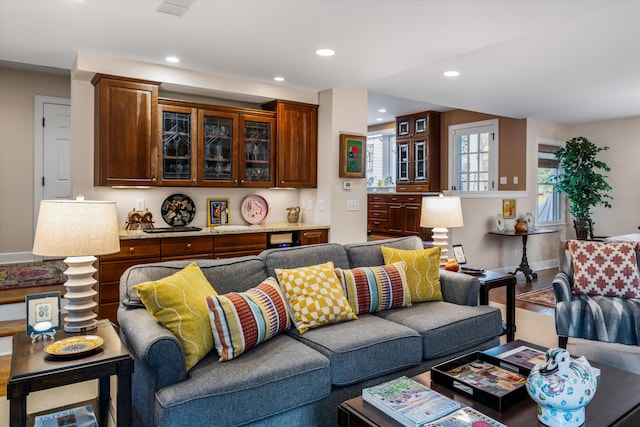 living area featuring recessed lighting, baseboards, and wood finished floors