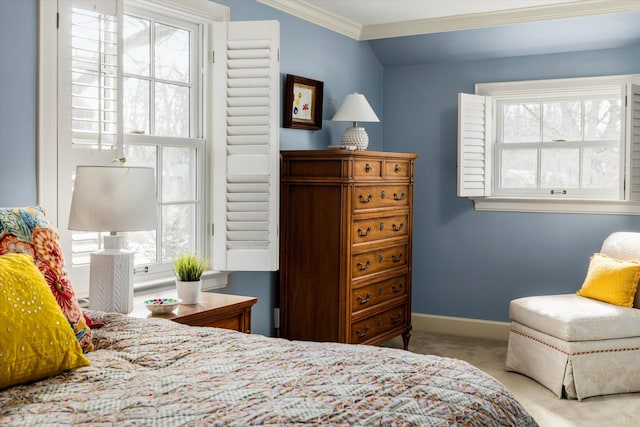 carpeted bedroom featuring lofted ceiling, baseboards, and crown molding