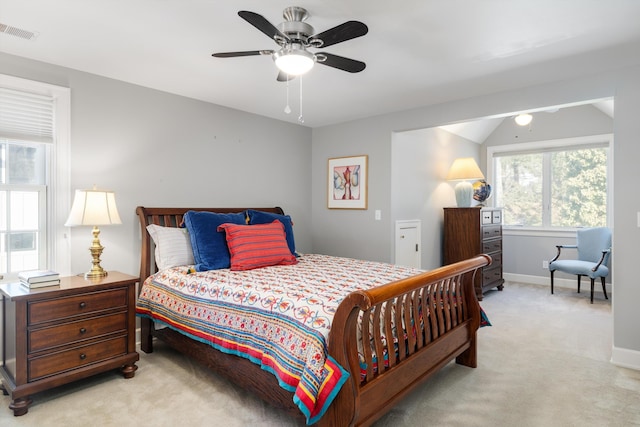 carpeted bedroom featuring vaulted ceiling, a ceiling fan, visible vents, and baseboards