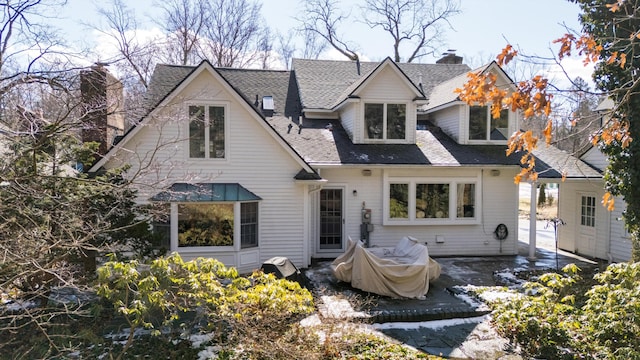 back of house featuring a patio and a shingled roof