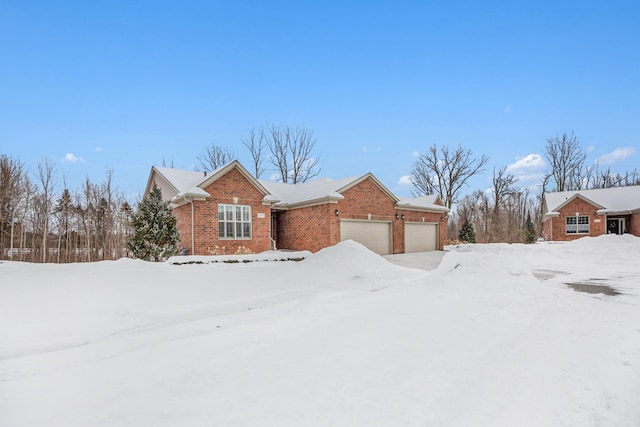 view of front of house featuring a garage and brick siding