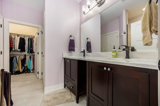 12341 Twin Brook Dr, Romeo, MI 48065 - full bathroom with baseboards, a spacious closet, and vanity