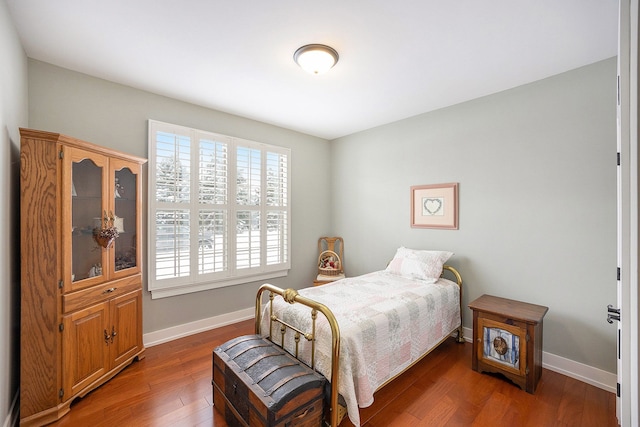 bedroom featuring dark wood-style floors and baseboards