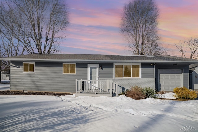 single story home featuring an attached garage and brick siding