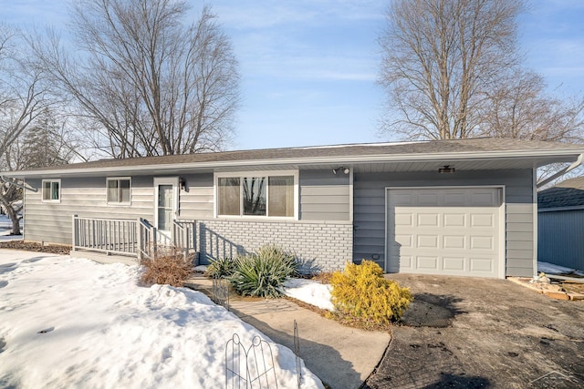 ranch-style home with brick siding, driveway, and an attached garage