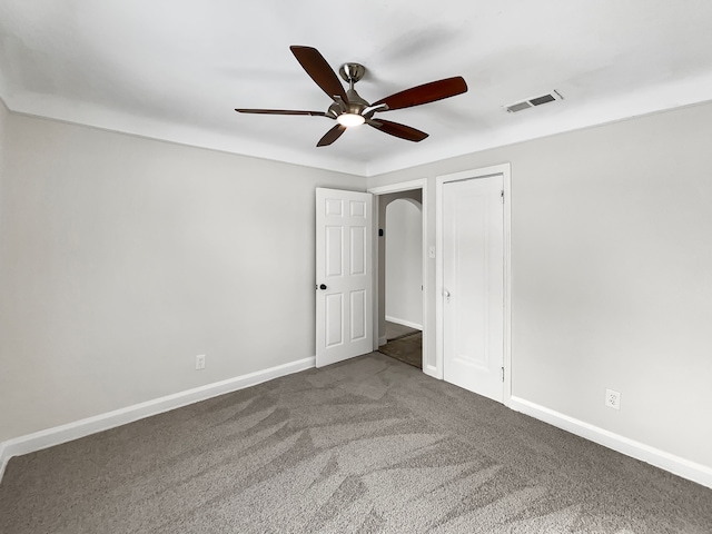 unfurnished bedroom featuring ceiling fan, carpet floors, visible vents, and baseboards