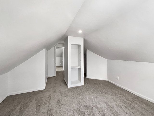 bonus room featuring carpet floors, baseboards, and lofted ceiling