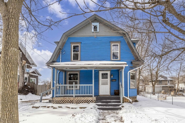 view of front facade featuring covered porch and a gambrel roof