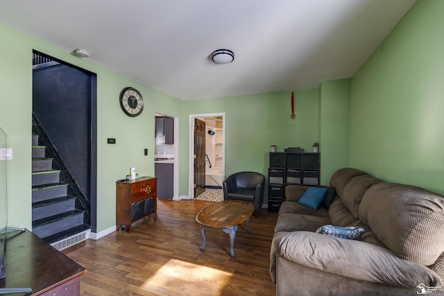 living area featuring stairs, baseboards, and dark wood finished floors