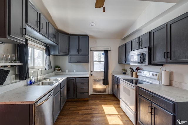 kitchen featuring appliances with stainless steel finishes, plenty of natural light, light countertops, and a sink