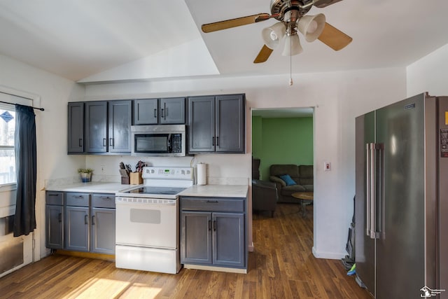 kitchen featuring gray cabinets, appliances with stainless steel finishes, light countertops, and dark wood-style flooring