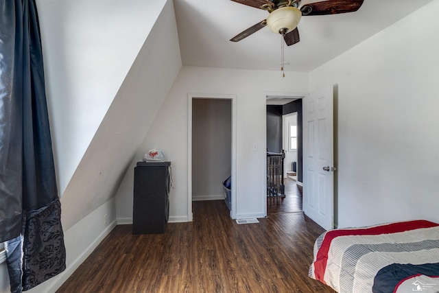 bedroom featuring dark wood-type flooring, a ceiling fan, and baseboards