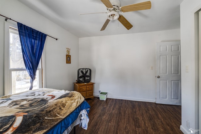 bedroom with dark wood-type flooring, ceiling fan, and baseboards