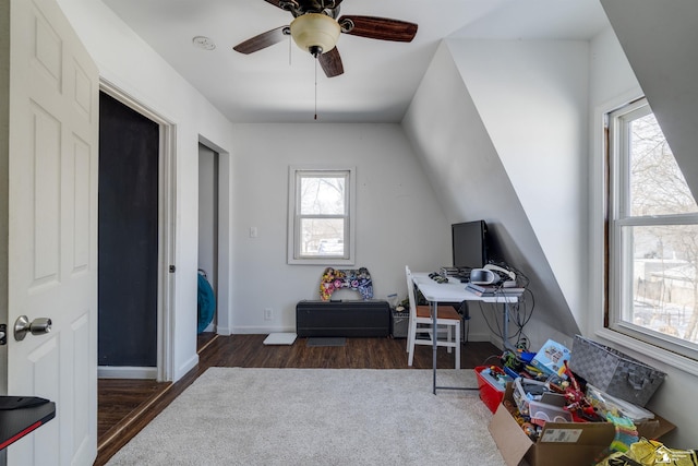 home office featuring lofted ceiling, dark wood-style flooring, ceiling fan, and baseboards