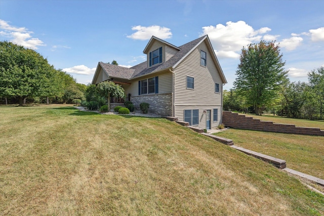 back of property featuring stone siding and a lawn