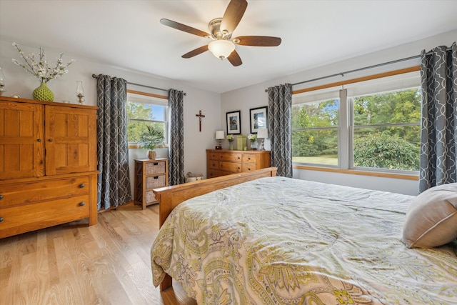 bedroom with a ceiling fan and light wood-style floors