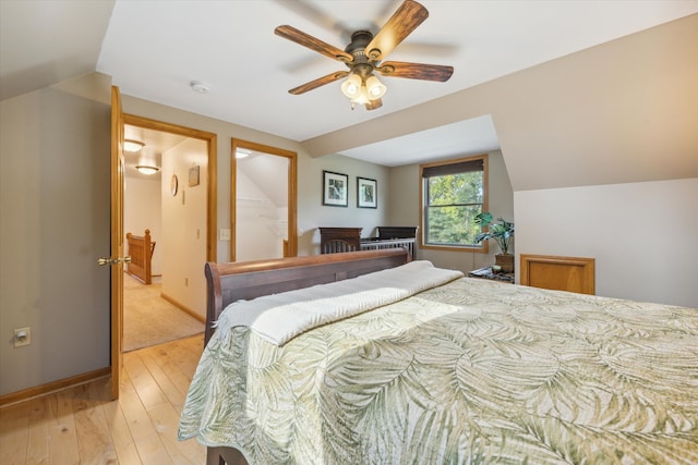 bedroom featuring a ceiling fan, light wood-type flooring, lofted ceiling, and baseboards