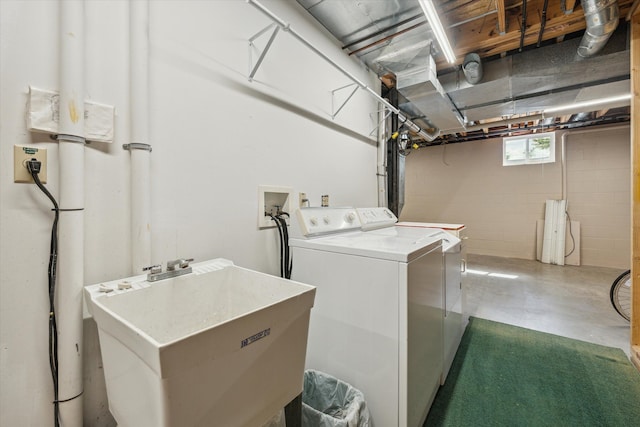 washroom featuring laundry area, a sink, and washing machine and clothes dryer