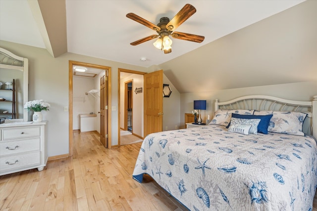 bedroom featuring light wood-style floors, lofted ceiling, baseboards, and a ceiling fan