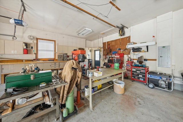 garage with electric panel, a workshop area, and a garage door opener