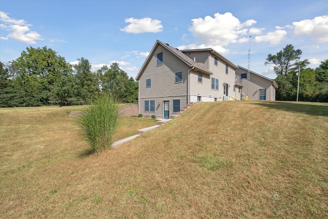 rear view of house featuring a lawn