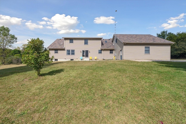 rear view of house with a lawn and a patio