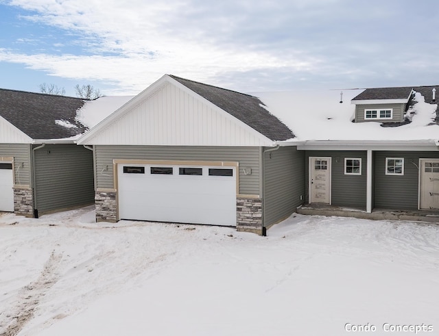 view of front of home featuring a garage and stone siding