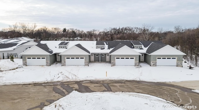 view of front of property with stone siding and an attached garage