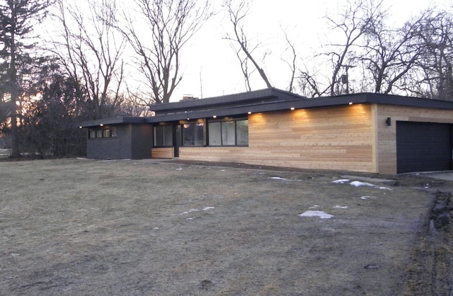 view of front facade featuring a garage and a chimney