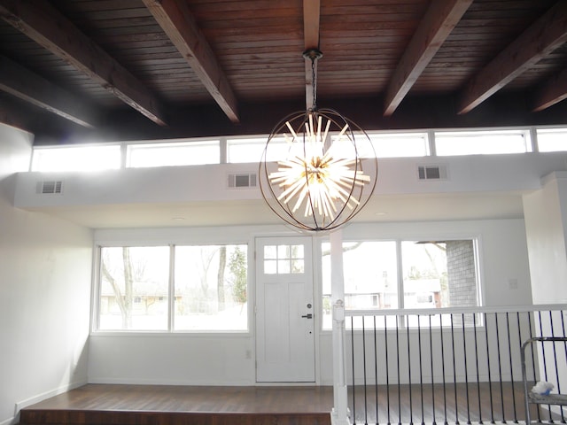 foyer with beam ceiling, visible vents, and a notable chandelier