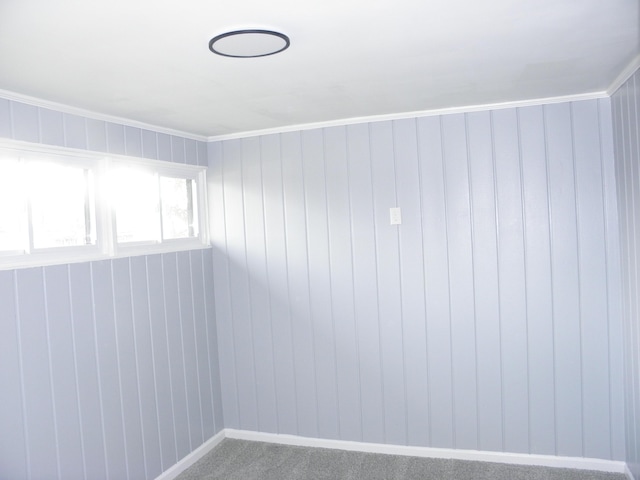 carpeted spare room featuring ornamental molding