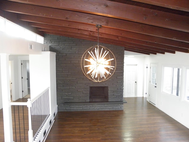 interior space featuring visible vents, dark wood-type flooring, vaulted ceiling with beams, a stone fireplace, and a notable chandelier