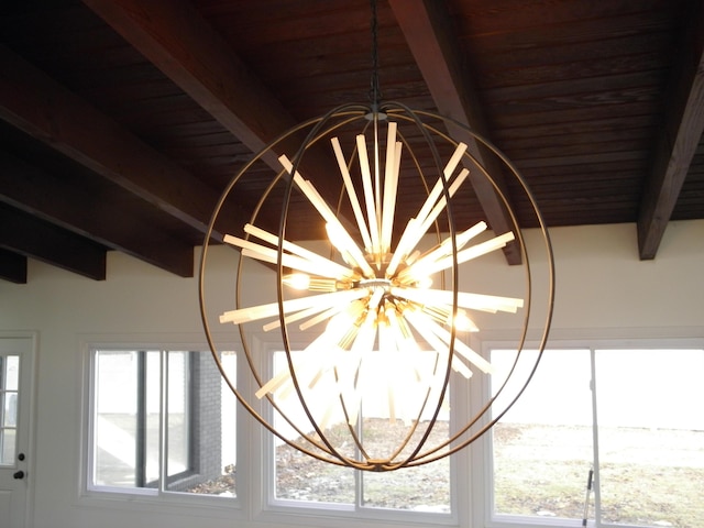 room details with beamed ceiling and an inviting chandelier