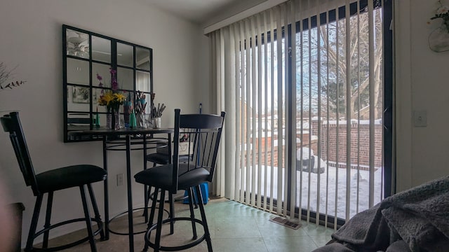 tiled dining space featuring visible vents