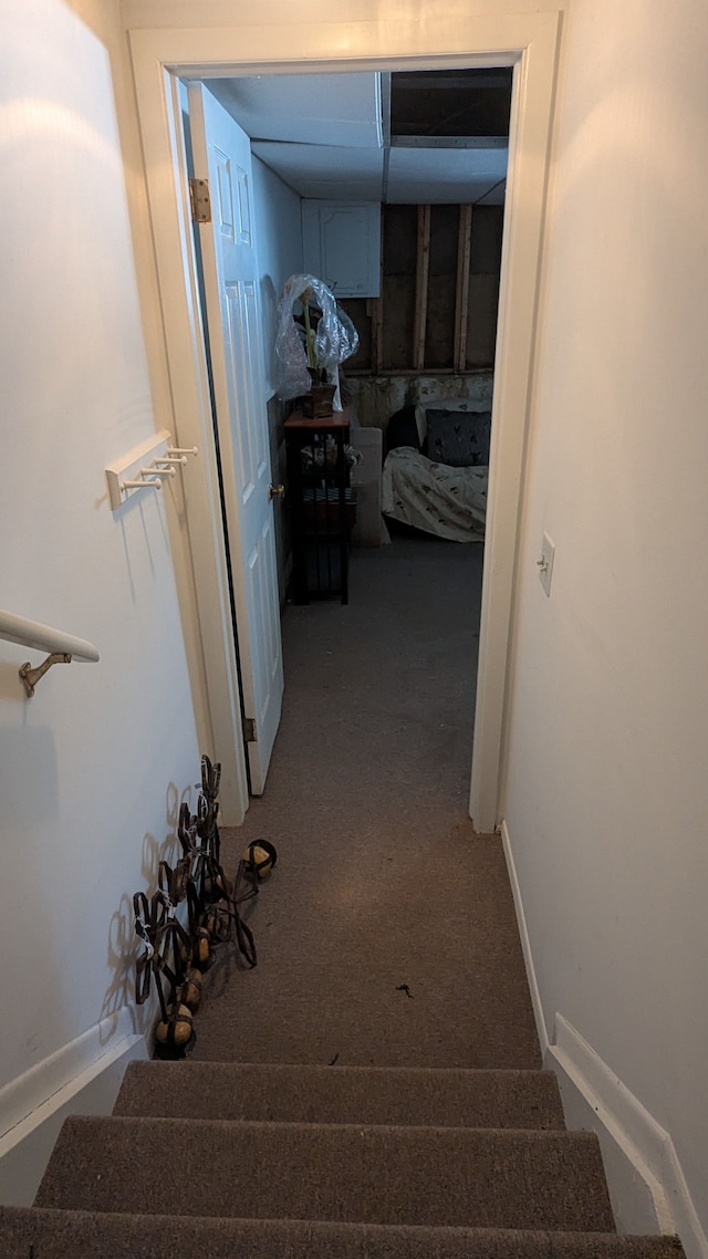 corridor featuring stairway, baseboards, and carpet floors