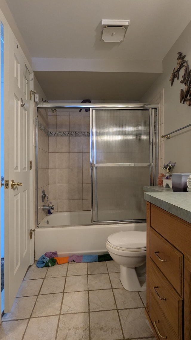 bathroom with combined bath / shower with glass door, toilet, and vanity