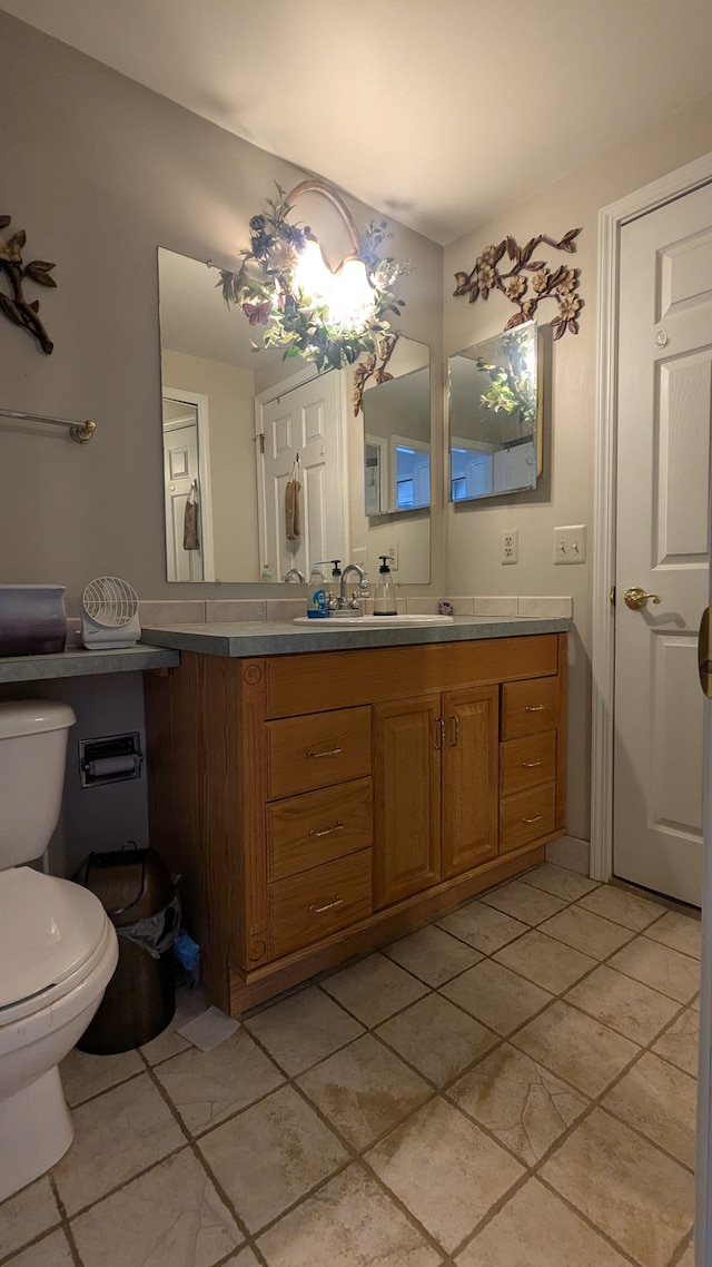 bathroom with toilet and vanity