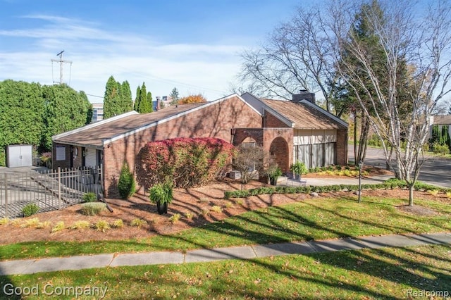 view of front of home with brick siding, fence, a chimney, a garage, and driveway