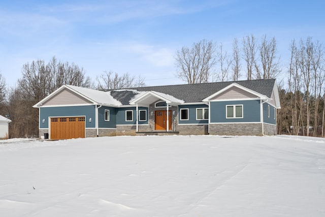 view of front of house with a garage and stone siding