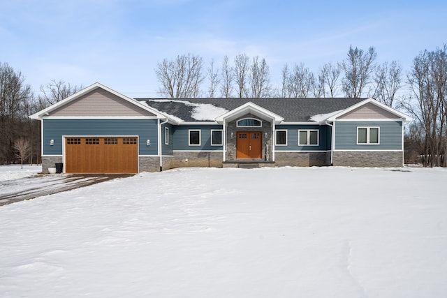 craftsman-style home with stone siding and an attached garage