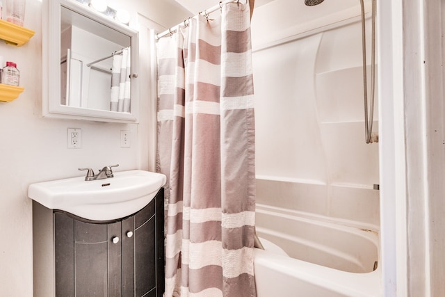 bathroom with shower / bath combo with shower curtain and vanity