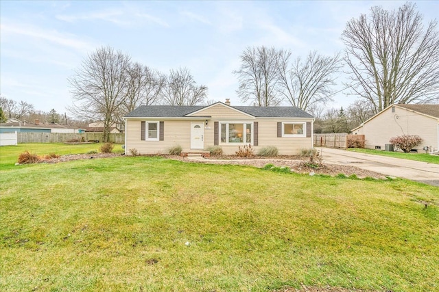 ranch-style house with concrete driveway, a front yard, and fence