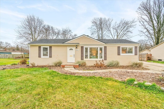 ranch-style home featuring driveway, a front yard, and fence