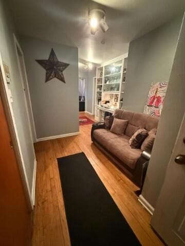 interior space featuring light wood-type flooring, baseboards, and built in features