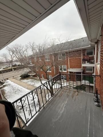 view of snow covered back of property