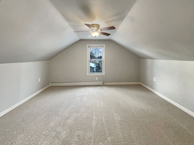 additional living space featuring carpet floors, baseboards, vaulted ceiling, and baseboard heating