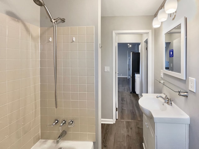 full bathroom featuring vanity, wood finished floors, and bathing tub / shower combination