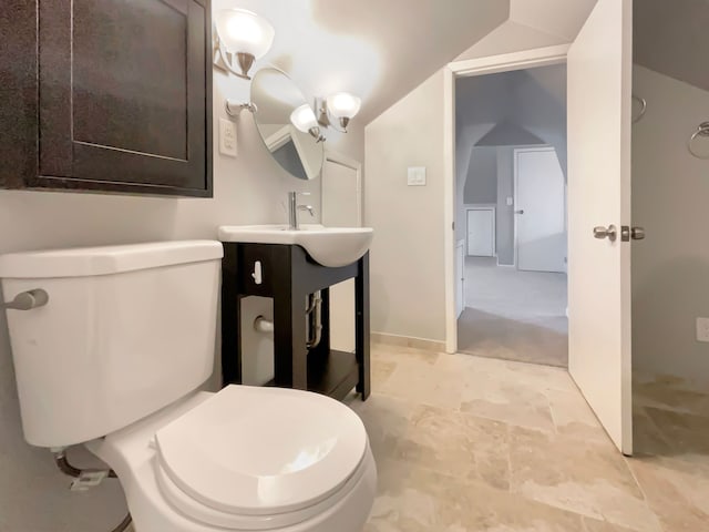 bathroom with vaulted ceiling, vanity, and toilet