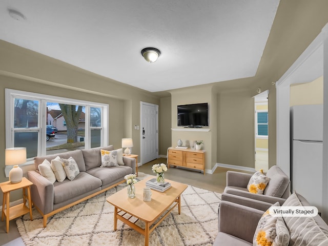 living room featuring light wood-style floors and baseboards