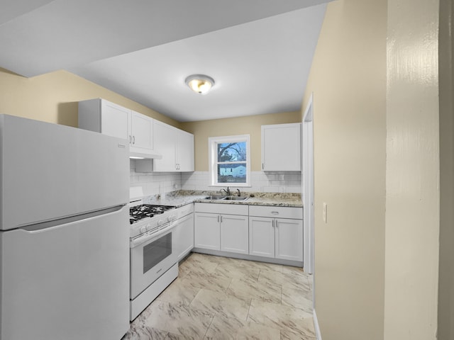 kitchen with white cabinets, freestanding refrigerator, marble finish floor, white gas stove, and a sink